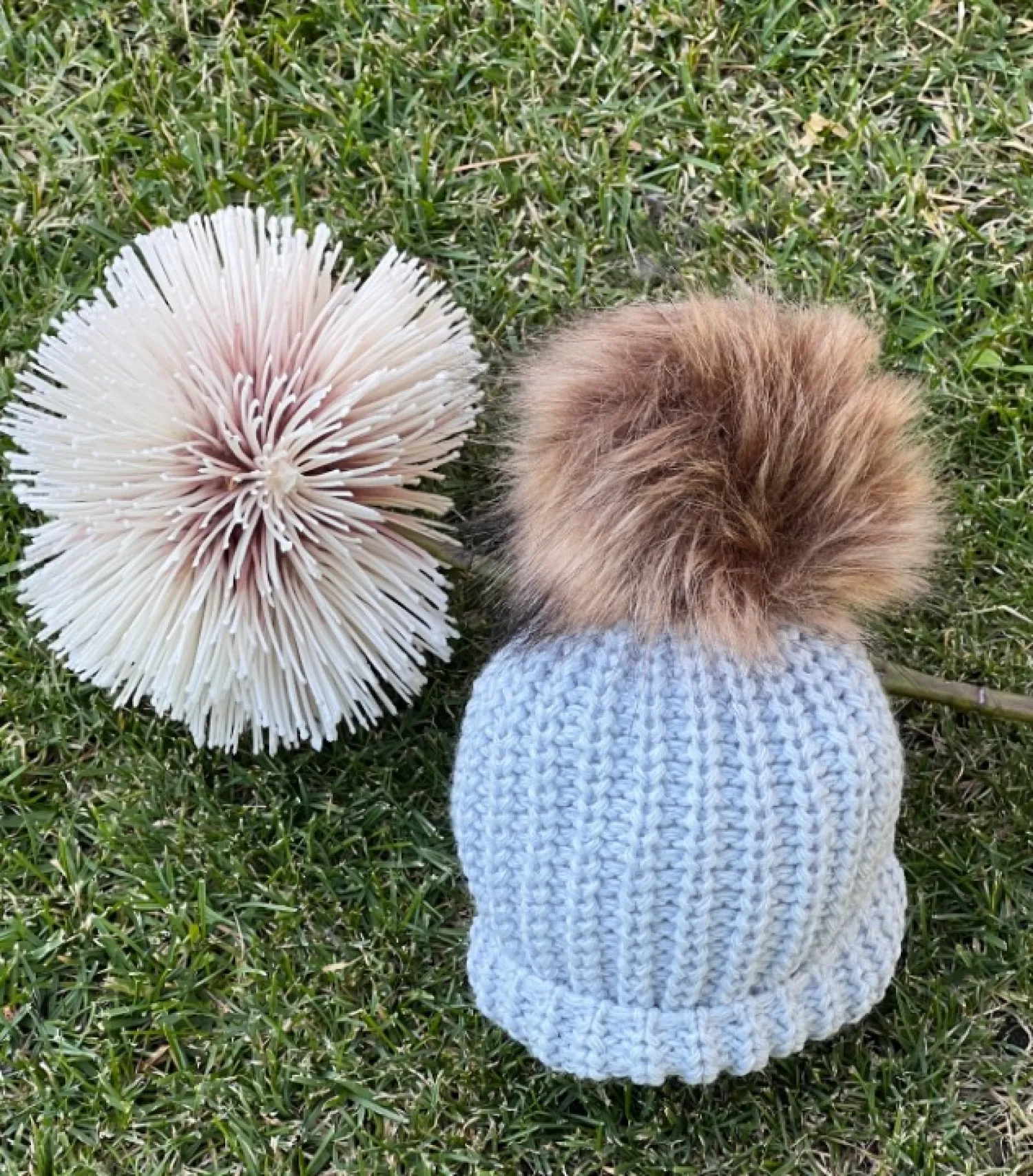 Gorrito de Bebé en punto gordito con pompón de pelo sintético.